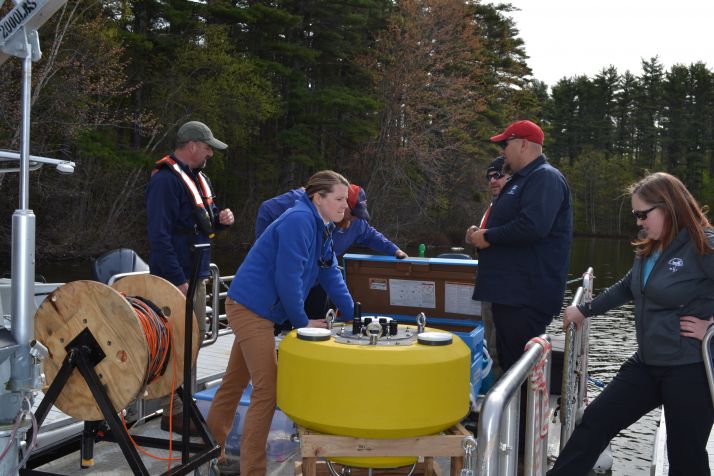 Researchers deploying a buoy