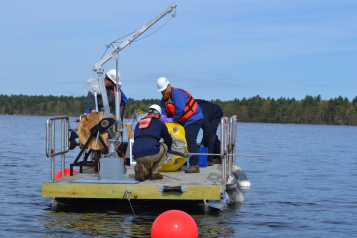 Researchers deploying a buoy