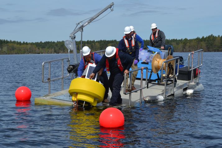 Researchers deploying a buoy