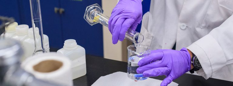 a scientist pouring water samples